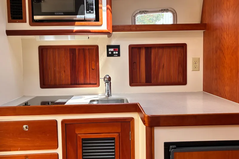 Slide: The Image of Little Harbor WhisperJet 40 (2000) yacht kitchen with wood cabinetry and modern appliances. - 29