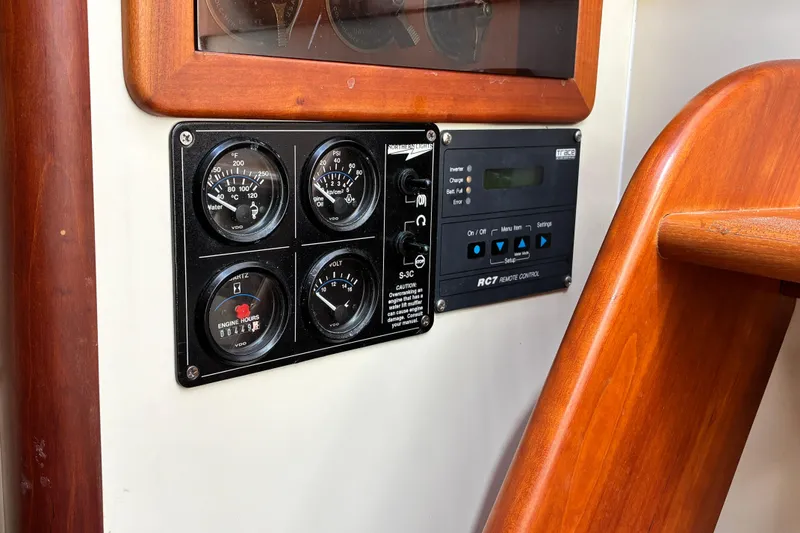 Slide: The Image of Control panel of a 2000 Little Harbor WhisperJet 40 boat, featuring gauges and remote control. - 50