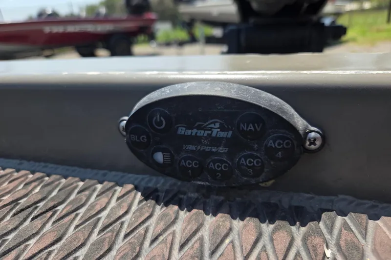 Slide: The Image of Control panel of 2024 Gator Tail Extreme series boat with multiple accessory buttons. - 9