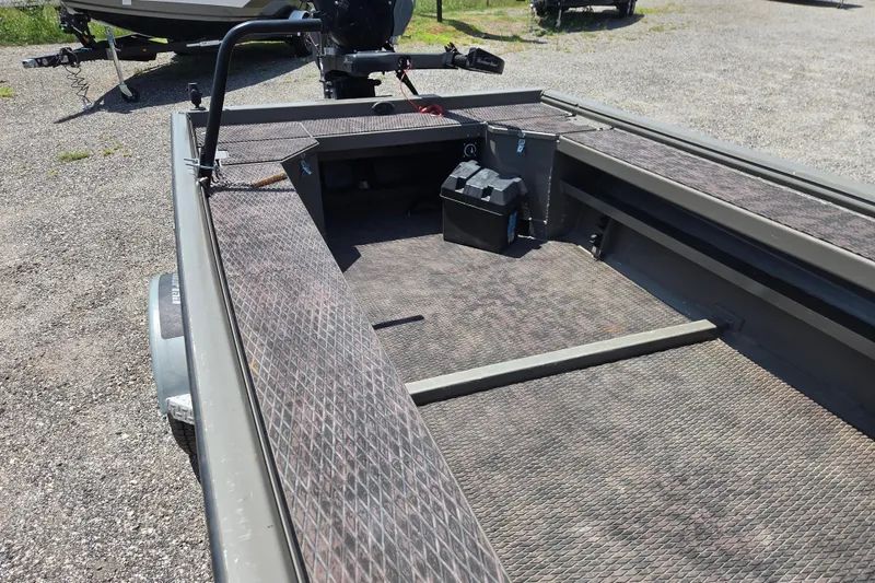 Slide: The Image of 2024 Gator Tail Extreme series boat interior with textured flooring and battery box. - 16