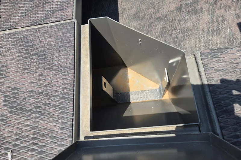 Slide: The Image of 2024 Gator Tail Extreme series boat compartment with textured flooring and metal storage area. - 14