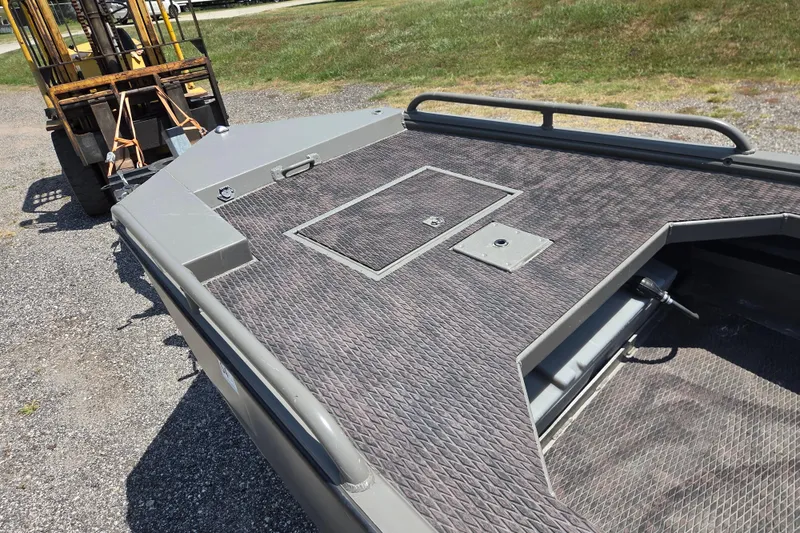 Slide: The Image of 2024 Gator Tail Extreme series boat deck with textured surface and storage hatch. - 11