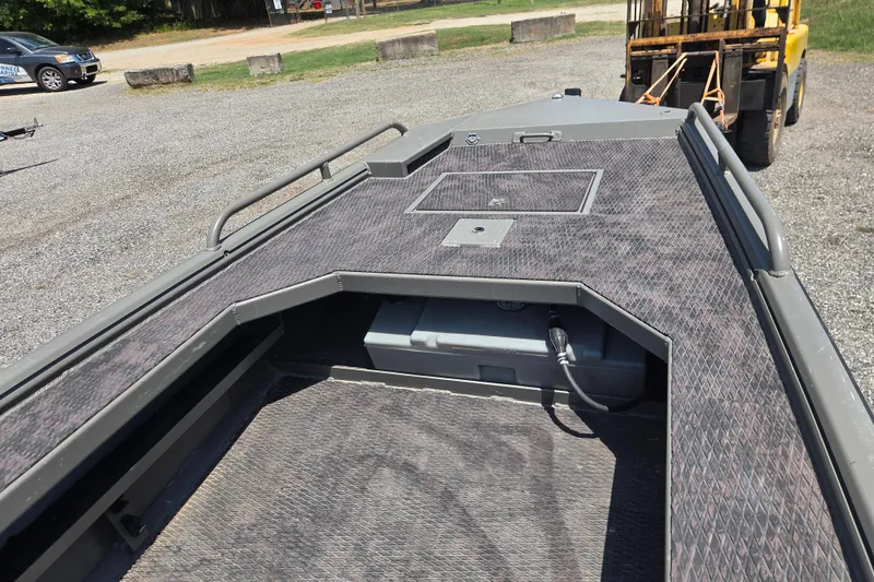 Slide: The Image of 2024 Gator Tail Extreme series boat deck with storage compartment, parked on gravel. - 19