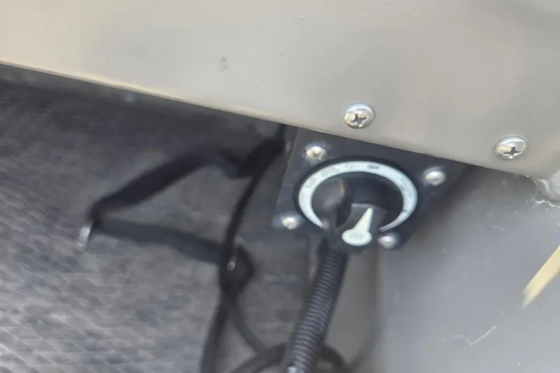 Slide: The Image of Control knob in a 2024 Gator Tail Extreme series boat, mounted on textured flooring. - 8