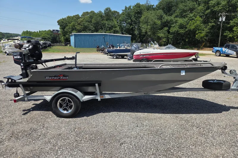 Slide: The Image of 2024 Gator Tail Extreme series boat on trailer in outdoor dealership setting. - 5