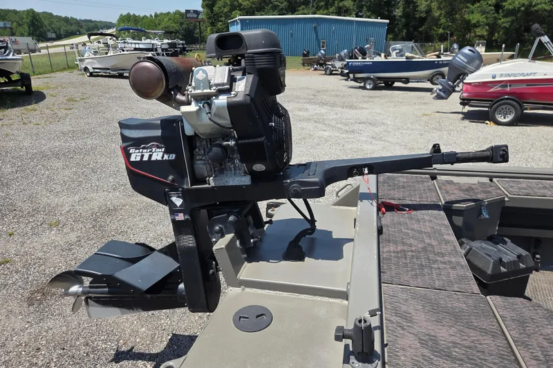 Slide: The Image of 2024 Gator Tail Extreme series boat motor in a marina setting. - 13