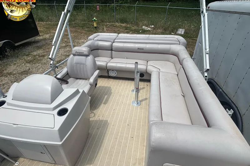 Slide: The Image of 2003 Sanpan 2200 LE pontoon boat interior with beige seating and steering console. - 8