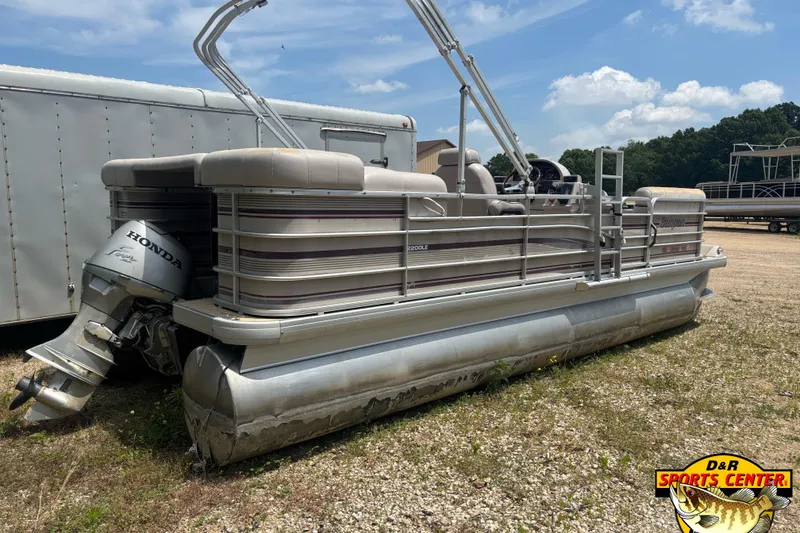 Slide: The Image of 2003 Sanpan 2200 LE pontoon boat with Honda engine, parked outdoors on gravel. - 3