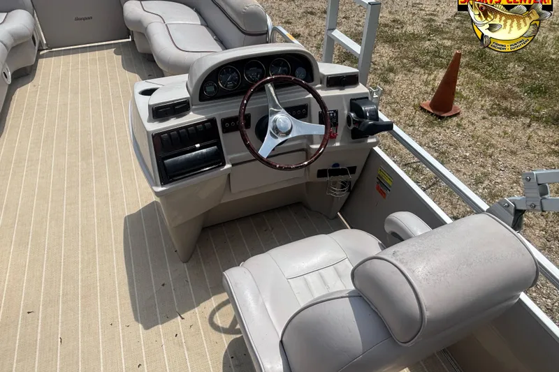 Slide: The Image of 2003 Sanpan 2200 LE boat interior with steering wheel and seating. - 6