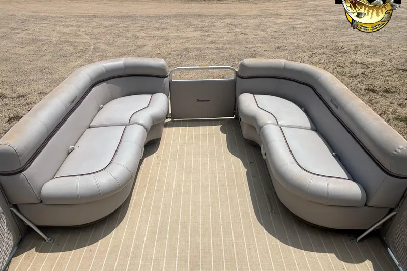 Slide: The Image of 2003 Sanpan 2200 LE pontoon boat interior with gray seating on a sandy background. - 5