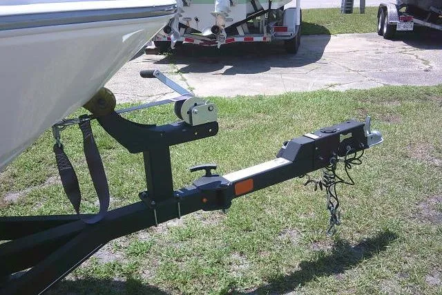 Slide: The Image of Trailer hitch of a 2022 Tahoe T16 boat on grass. - 5