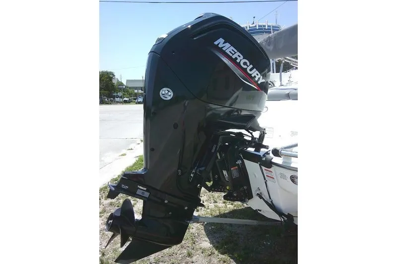 Slide: The Image of 2022 Tahoe T16 boat with Mercury outboard motor, parked outdoors. - 8