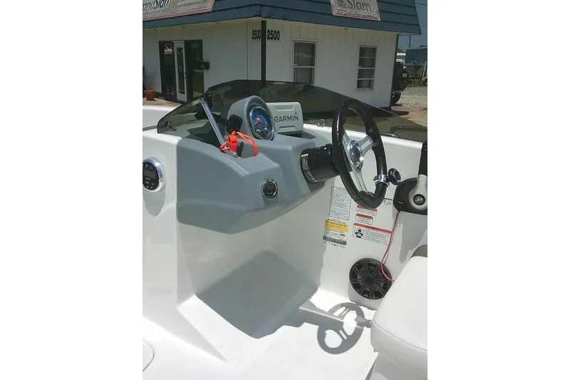 Slide: The Image of 2022 Tahoe T16 boat dashboard with steering wheel and Garmin navigation system. - 12
