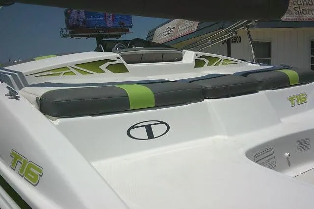 Slide: The Image of 2022 Tahoe T16 boat with green and gray seating, showcasing sleek design and branding. - 9