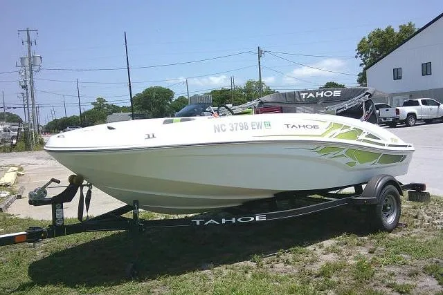 Slide: The Image of 2022 Tahoe T16 boat on trailer, parked outdoors, featuring sleek design and vibrant graphics. - 3