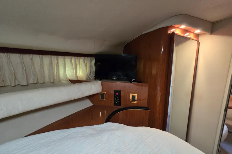 Slide: The Image of Interior cabin of 1999 Sea Ray Sundancer 400 with TV and wood paneling. - 11