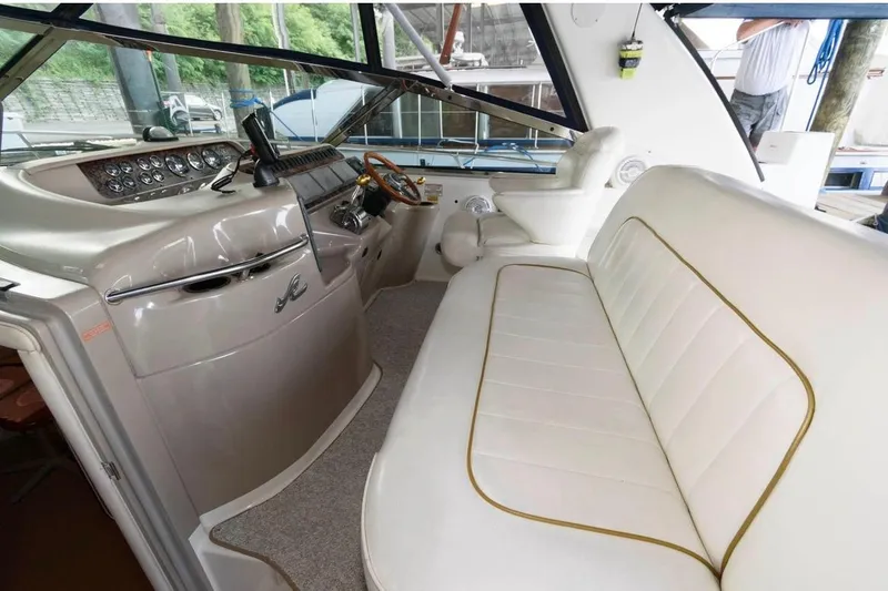 Slide: The Image of Interior of a 1999 Sea Ray Sundancer 400 yacht with plush seating and sleek dashboard. - 17