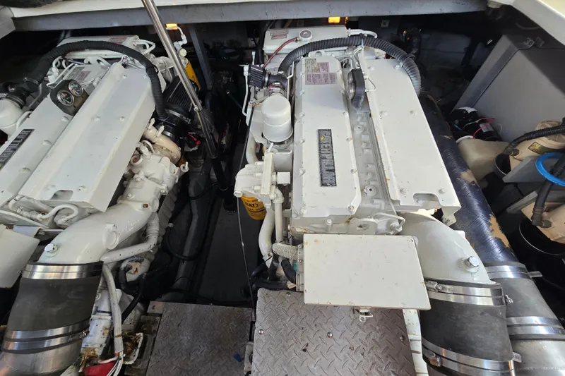 Slide: The Image of Engine room of a 1999 Sea Ray Sundancer 400, showcasing dual marine engines. - 23