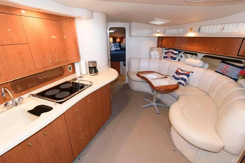 Slide: The Image of Luxurious interior of 1999 Sea Ray Sundancer 400 yacht with kitchen and seating area. - 9