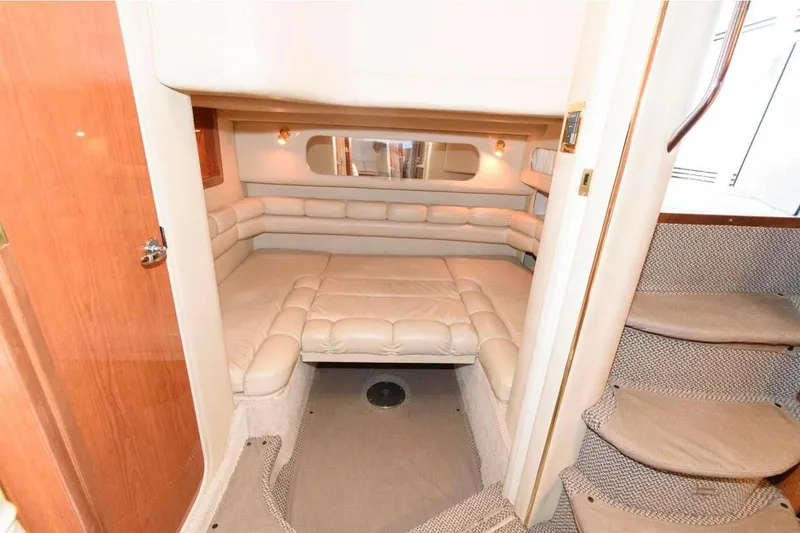 Slide: The Image of Interior cabin of 1999 Sea Ray Sundancer 400 yacht with plush seating and cozy ambiance. - 13