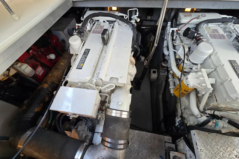 Slide: The Image of Engine room of a 1999 Sea Ray Sundancer 400, showcasing dual marine engines. - 24