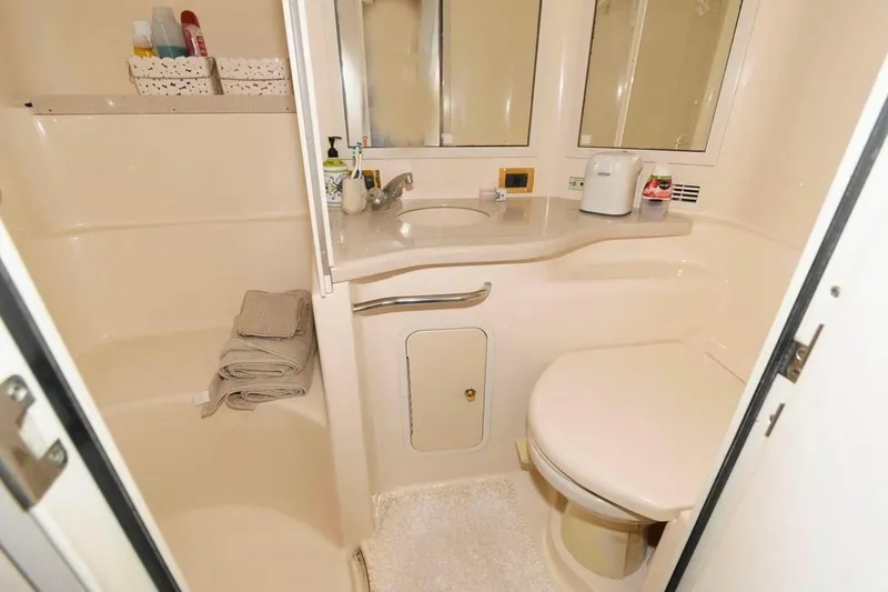 Slide: The Image of Bathroom interior of 1999 Sea Ray Sundancer 400 yacht, featuring sink, toilet, and storage. - 14
