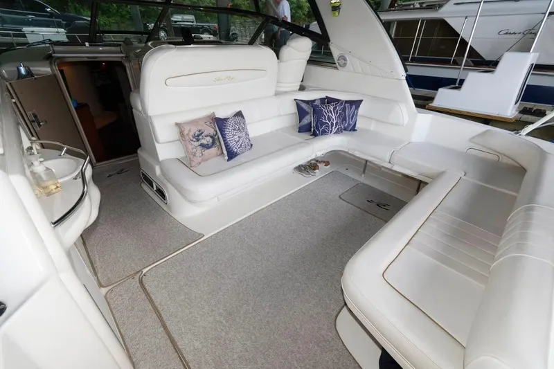 Slide: The Image of Luxurious interior of a 1999 Sea Ray Sundancer 400 yacht with plush seating and decorative pillows. - 18