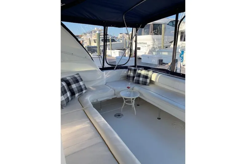 Slide: The Image of 1999 Sea Ray Sundancer 400 yacht interior with white seating and plaid pillows. - 20