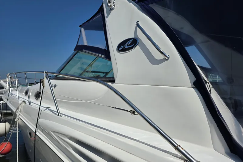 Slide: The Image of 1999 Sea Ray Sundancer 400 yacht docked, showcasing sleek design and polished exterior. - 5