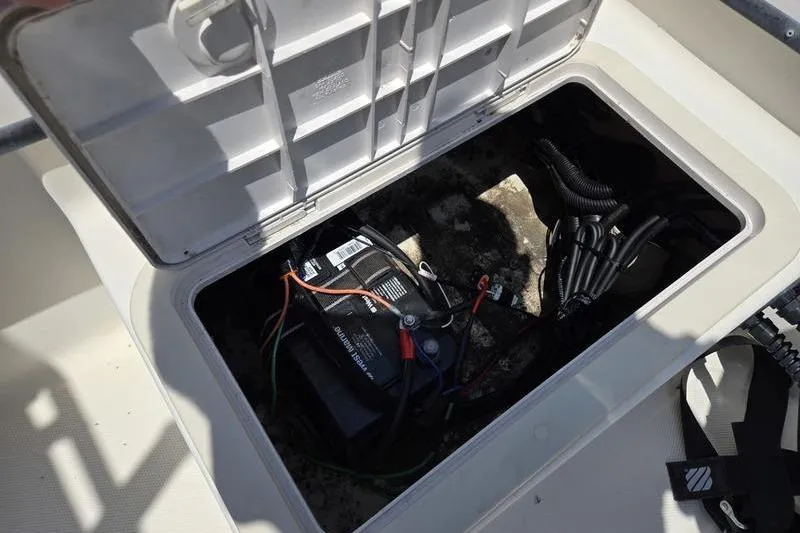 Slide: The Image of Open hatch on 2000 May-Craft 2000CC boat showing battery and wiring. - 18