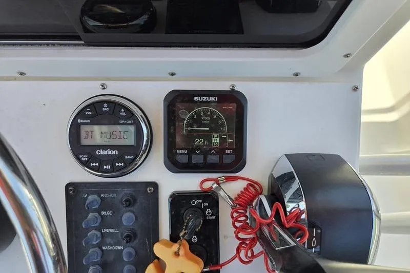Slide: The Image of Control panel of a 2000 May-Craft 2000CC boat with Suzuki and Clarion displays. - 12