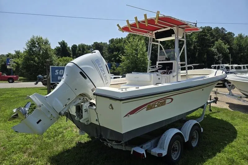 Slide: The Image of 2000 May-Craft 2000CC boat with Suzuki outboard motor on trailer, parked on grass. - 14