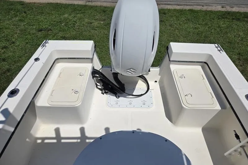 Slide: The Image of May-Craft 2000CC boat deck with storage compartments and outboard motor, year 2000 model. - 15
