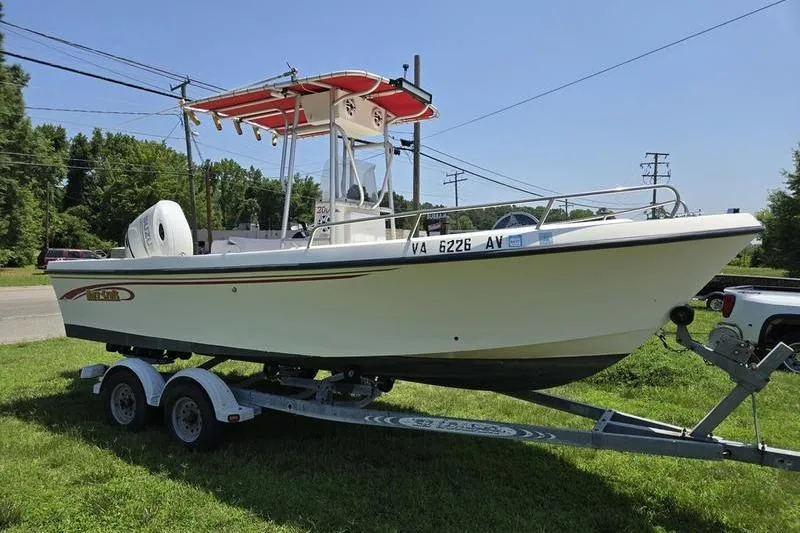 The Image of 2000 May-Craft 2000CC boat on trailer, parked on grass, with red canopy. - 0
