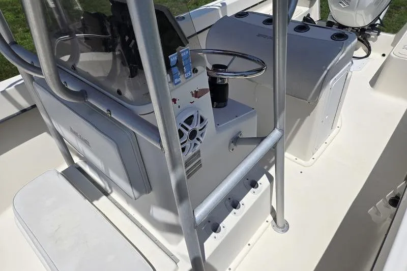 Slide: The Image of Interior view of a 2000 May-Craft 2000CC boat, featuring steering console and seating. - 3