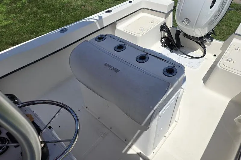 Slide: The Image of May-Craft 2000CC boat interior with steering wheel and Suzuki outboard motor. - 7