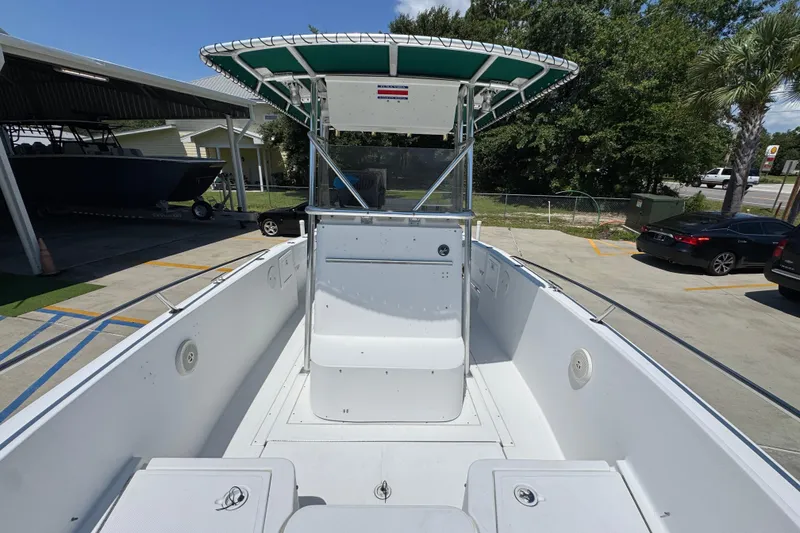 Slide: The Image of 2000 Stamas 250 Tarpon boat with T-top, parked outdoors on a sunny day. - 24