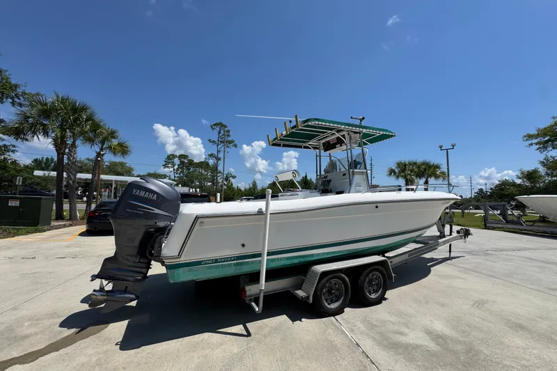 Slide: The Image of 2000 Stamas 250 Tarpon boat on trailer with Yamaha outboard motor, parked outdoors. - 11