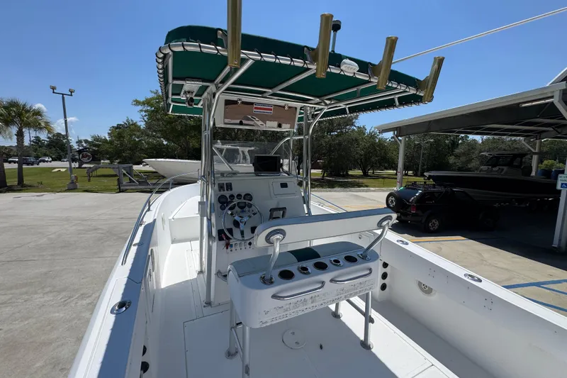 Slide: The Image of 2000 Stamas 250 Tarpon boat with green canopy, docked outdoors on a sunny day. - 41