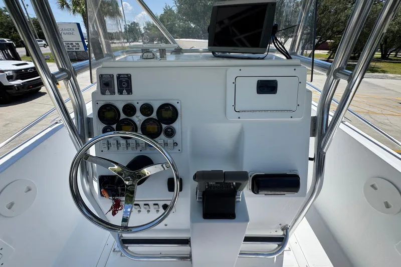 Slide: The Image of Center console of a 2000 Stamas 250 Tarpon boat with steering wheel and gauges. - 36