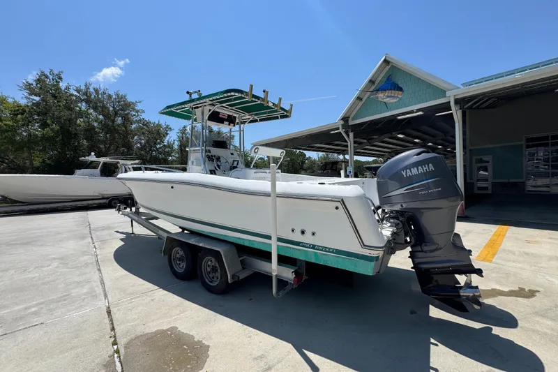 Slide: The Image of 2000 Stamas 250 Tarpon boat with Yamaha engine on trailer, parked outdoors. - 17