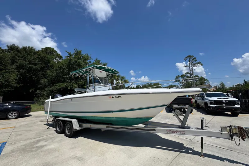 Slide: The Image of 2000 Stamas 250 Tarpon boat on trailer under clear blue sky. - 8