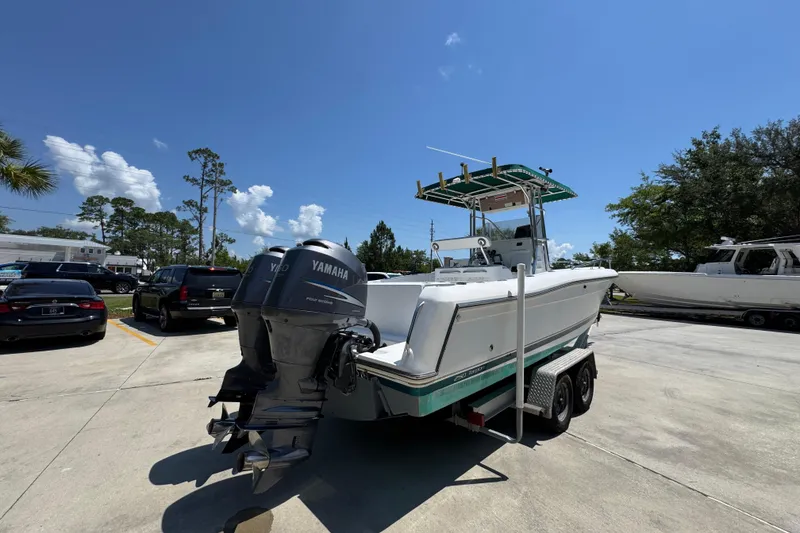 Slide: The Image of 2000 Stamas 250 Tarpon boat with Yamaha outboard engines on a trailer in a parking lot. - 12