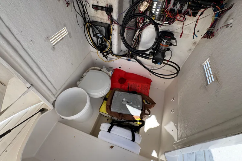 Slide: The Image of Storage compartment of a 2000 Stamas 250 Tarpon boat with equipment and wiring. - 28