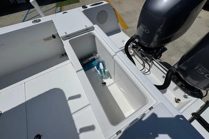 Slide: The Image of Open storage compartment on 2000 Stamas 250 Tarpon boat with twin Yamaha 150 engines. - 45