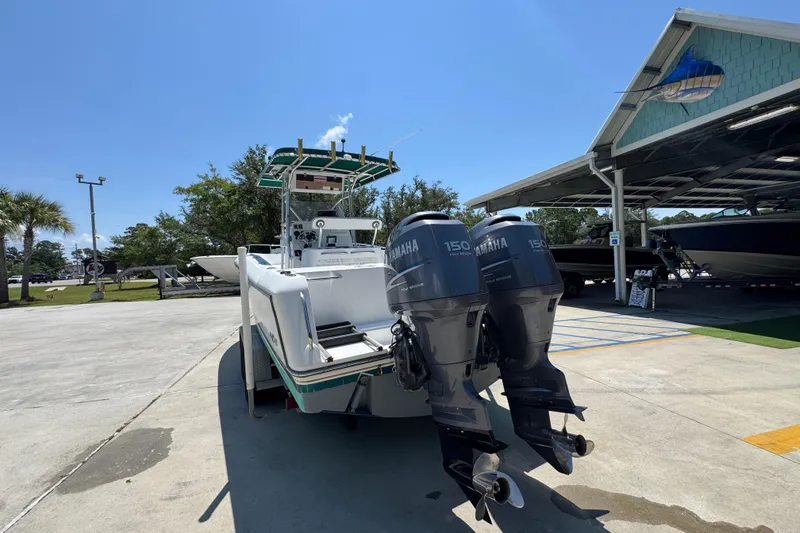 Slide: The Image of 2000 Stamas 250 Tarpon boat with twin Yamaha 150 engines in a sunny marina. - 15