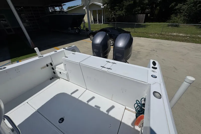 Slide: The Image of 2000 Stamas 250 Tarpon boat with twin Yamaha 150 engines, docked outdoors. - 43