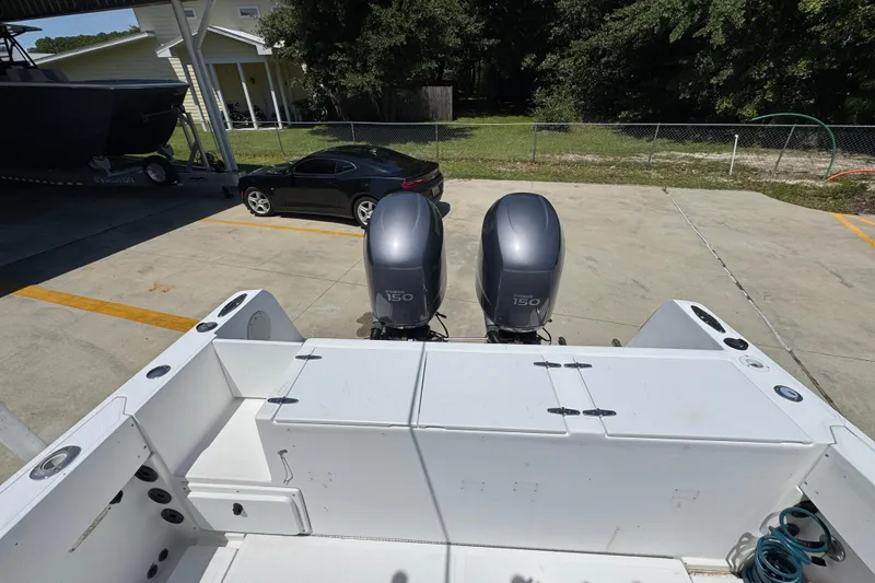 Slide: The Image of 2000 Stamas 250 Tarpon boat with dual Yamaha 150 engines in a driveway setting. - 44
