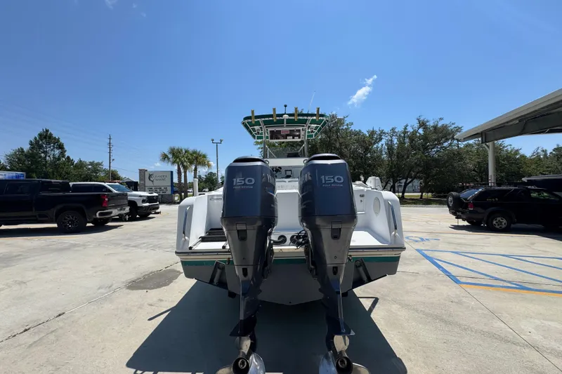 Slide: The Image of 2000 Stamas 250 Tarpon boat with dual 150 horsepower engines in a parking lot. - 14