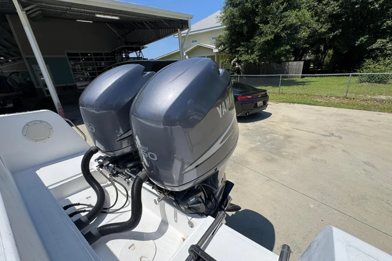 Slide: The Image of Twin Yamaha outboard engines on a 2000 Stamas 250 Tarpon boat, parked outdoors. - 48